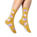 [lf] Person wearing mustard yellow crew socks with a pattern of purple and cream hedgehogs against a black background.