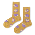 Pair of mustard yellow crew socks featuring a pattern of cute hedgehogs with bright purple quills and little pink feet.