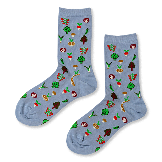 Light blue crew socks with a repeating pattern of small vegetables including tomatoes, artichokes, radishes, and mushrooms.