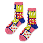 Crew socks with a colorful patchwork design of strawberries, tulips, polka dots and stripes separated by wavy blue borders.