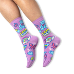 [lf] A person wearing purple crew socks featuring a retro charm pattern with teddy bears and keyboards on a black background.