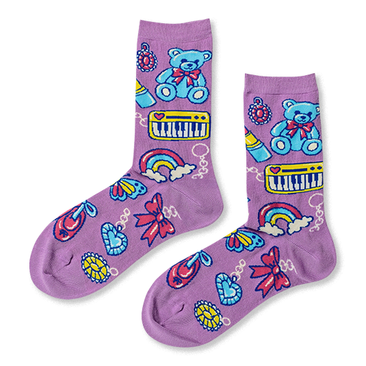 Purple crew socks featuring a retro trinket pattern with blue teddy bears, yellow keyboards, rainbows, and dangling charms.