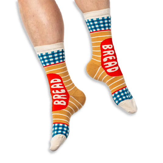 [lf] A person wearing tan striped socks with blue gingham details and a red BREAD label on a black background.
