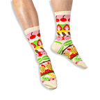 [lf] A person wearing cream crew socks featuring horizontal colorful stripes of pastries, cherries, and citrus slices.