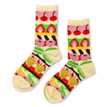 Cream crew socks with colorful horizontal bands showing patisserie items like cherries, strawberries, madeleines, and citrus.
