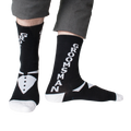 Lifestyle shot: Man modeling black 'Groomsman' socks with gray pants.  Shows the full sock design.