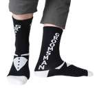 Lifestyle shot: Man modeling black 'Groomsman' socks with gray pants.  Shows the full sock design.