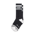 Pair of black crew socks with white stripes and 'DADDY' text.  Sporty and playful design.