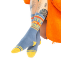 Close-up shot: 'It's Ok to Fart' socks on a person's legs; the focus is on the socks' design and texture.