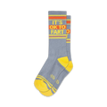 Pair of gray crew socks with yellow and orange stripes and the phrase 'It's Ok to Fart'.