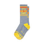 Pair of gray crew socks with yellow and orange stripes and the phrase 'It's Ok to Fart'.