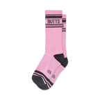 Pair of pink crew socks with black stripes and 'BUTTS' written across the top. Fun, casual style.