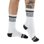 Lifestyle shot of 'Bitch' socks on a woman's legs, showcasing the fit and style.
