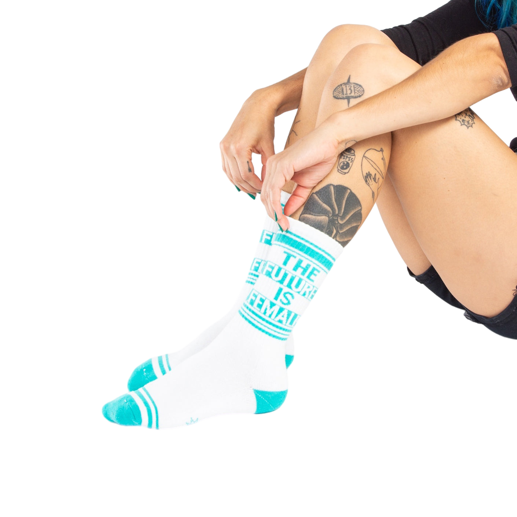 Lifestyle shot of a person's legs wearing the 'The Future is Female' socks.
