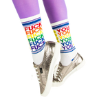 Lifestyle shot of model wearing 'Fuck You' socks with silver sneakers and purple tights.