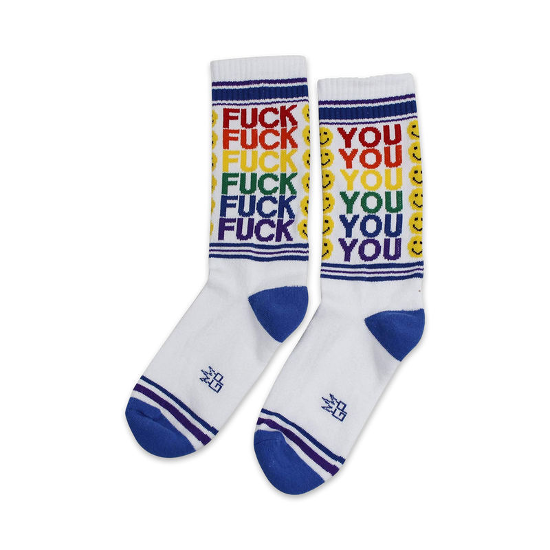 Pair of white crew socks with rainbow 'FUCK YOU' text and smiley faces. Blue and purple stripes at the cuff.