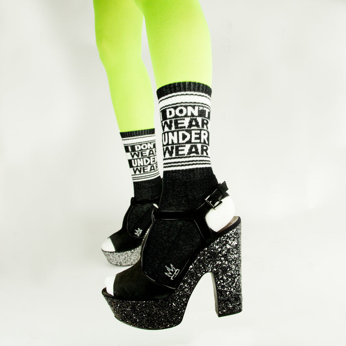 A pair of black socks with white toes and heels and white lettering that reads 