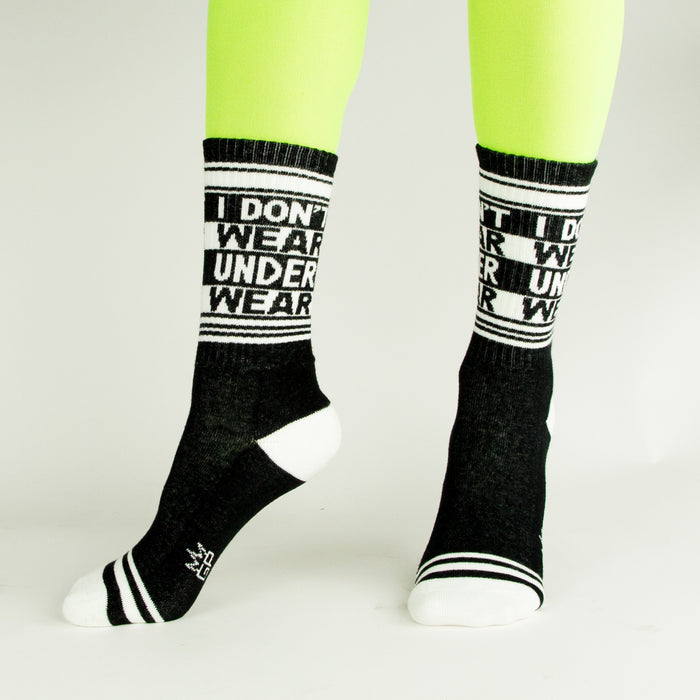 A pair of black socks with white toes and heels and white lettering that reads 
