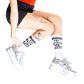 Lifestyle shot: Person wearing white 'I'd Fuck Me' socks with silver platform shoes.