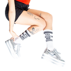 Lifestyle shot: Person wearing white 'I'd Fuck Me' socks with silver platform shoes.