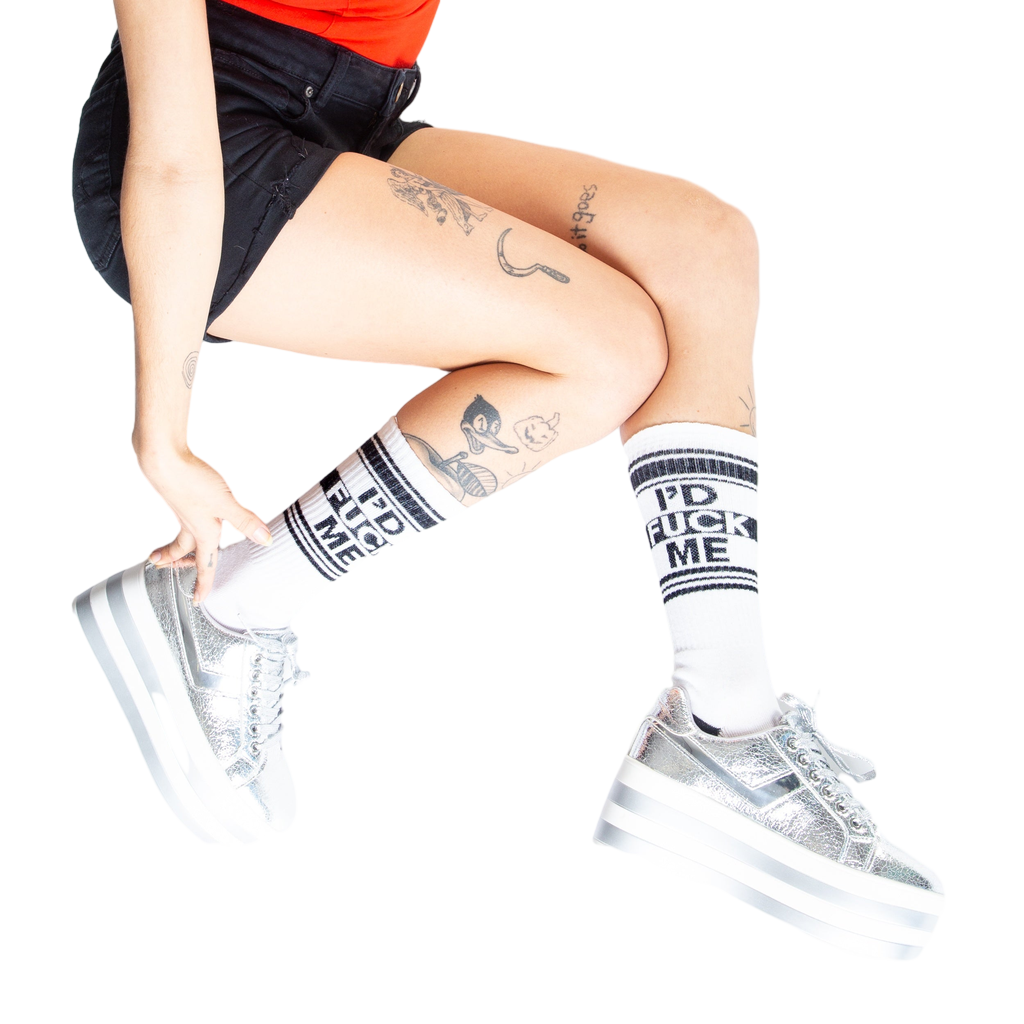 Lifestyle shot: Person wearing white 'I'd Fuck Me' socks with silver platform shoes.