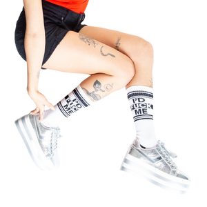 Lifestyle shot: Person wearing white 'I'd Fuck Me' socks with silver platform shoes.