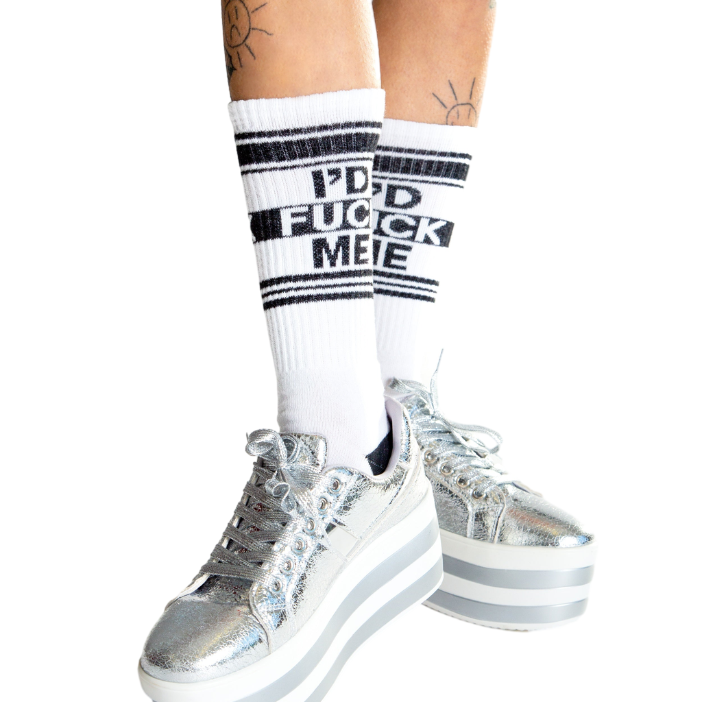 Lifestyle shot: Person wearing white 'I'd Fuck Me' socks, sitting with legs apart.