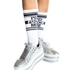 Lifestyle shot: Person wearing white 'I'd Fuck Me' socks, sitting with legs apart.
