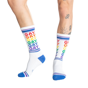 Studio shot: Two pairs of Gay Rainbow socks laid flat.