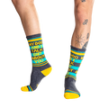 Lifestyle shot:  Person wearing 'My Dog and I Talk Shit About You' socks, showcasing the fit and design.