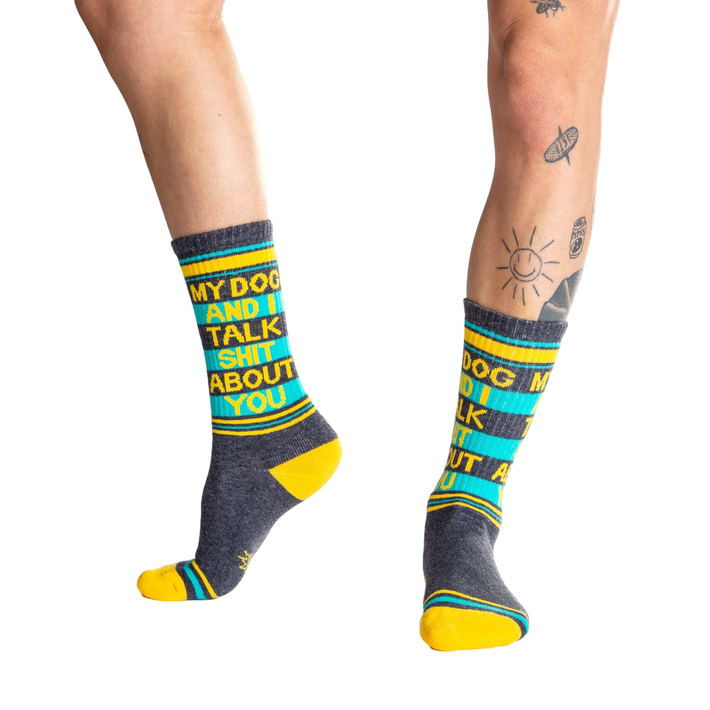 Lifestyle shot:  Person wearing 'My Dog and I Talk Shit About You' socks, showcasing the fit and design.