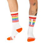 Lifestyle shot of a person wearing the Brooklyn rainbow socks, showing how they look when worn.