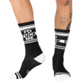 Lifestyle shot: Person wearing black 'I'd Fuck Me' socks with black shoes.