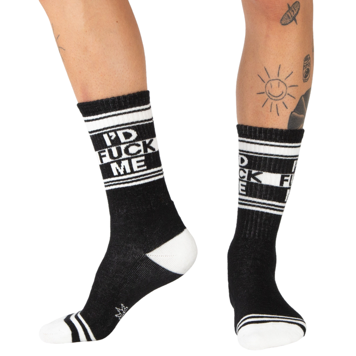 Lifestyle shot: Person wearing black 'I'd Fuck Me' socks with black shoes.