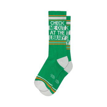 Pair of green crew socks with orange and white stripes and the text 'Check Me Out At The Library'.