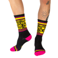Lifestyle photo showing a person wearing the black 'Everything Hurts And I'm Dying' crew socks.