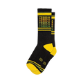 Crew socks in black with a repeating 'Tequila' pattern in yellow, orange, and green. Yellow and dark green stripes at the cuff.