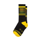 Crew socks in black with a repeating 'Tequila' pattern in yellow, orange, and green. Yellow and dark green stripes at the cuff.