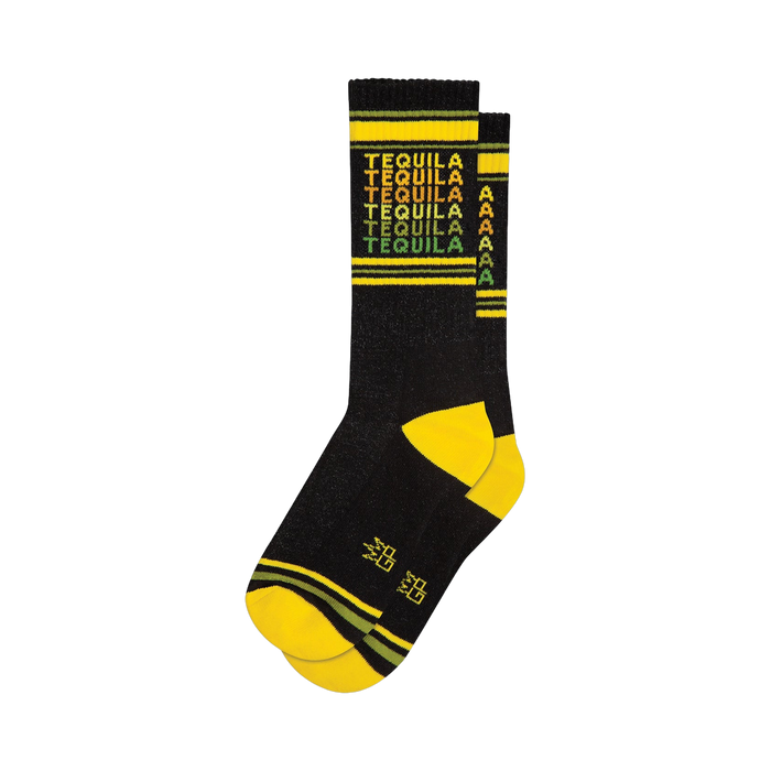 Crew socks in black with a repeating 'Tequila' pattern in yellow, orange, and green. Yellow and dark green stripes at the cuff.