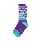 Pair of purple and teal crew socks with the text 'Be The Person Your Dog Thinks You Are' written vertically.