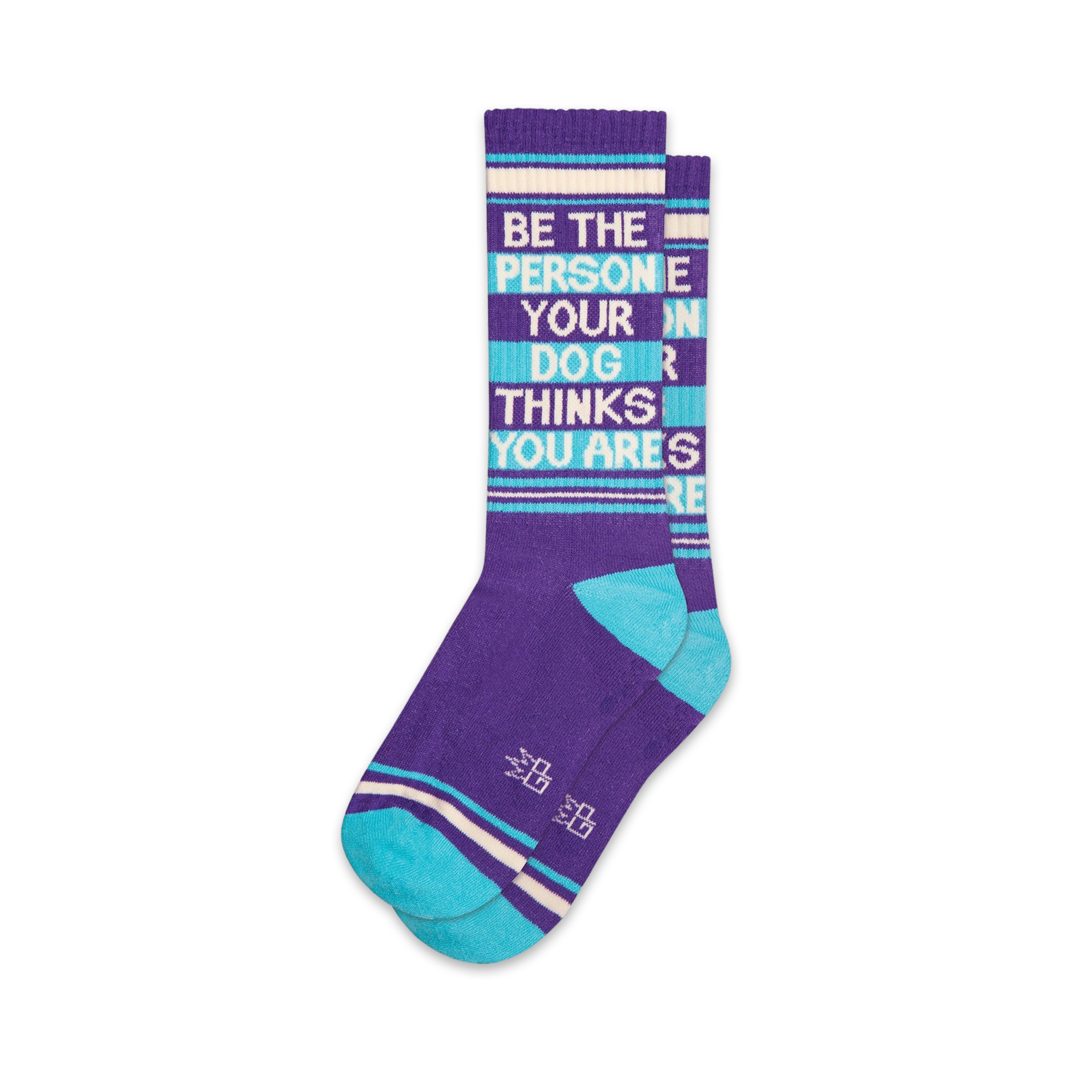 Pair of purple and teal crew socks with the text 'Be The Person Your Dog Thinks You Are' written vertically.