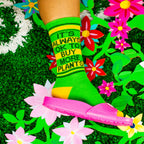 A close-up shot of the socks on a person's feet against a floral background. [lf]