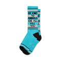 Pair of teal crew socks with black accents and the text 'Be Kind To Animals Or I'll Kill You'.