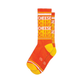 Pair of orange crew socks with a repeating 'CHEESE' pattern in a lighter orange and white. Yellow stripes are visible at the top and bottom cuffs.