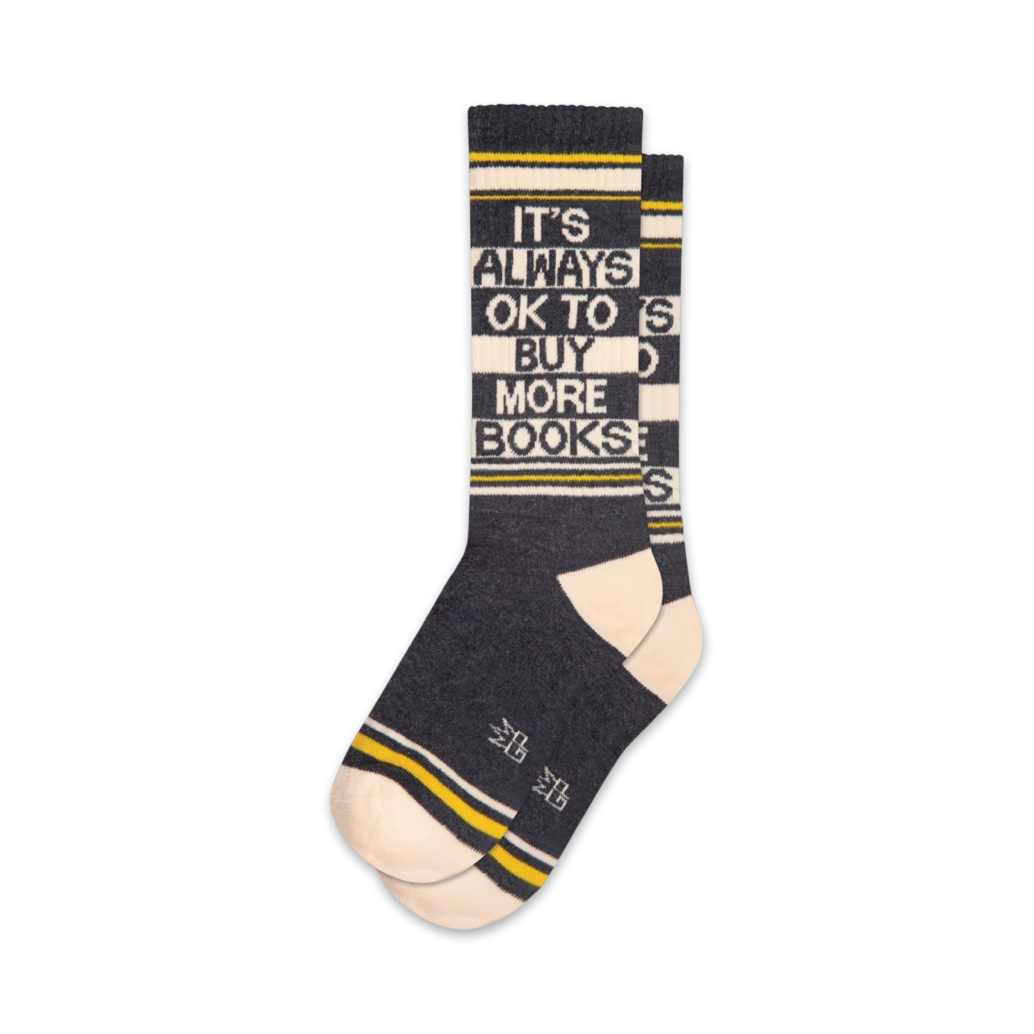 Pair of crew socks in dark grey, white, and yellow.  The socks feature the text 'It's Always Ok To Buy More Books!' in a striped design.
