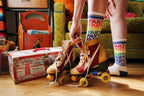Lifestyle shot of model wearing the 'Farts' socks with roller skates. [lf]