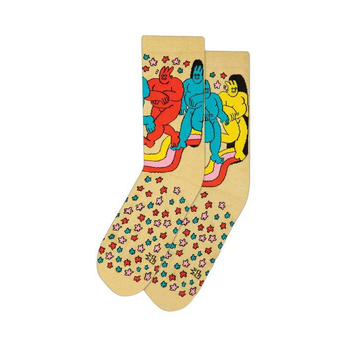 Cream-colored crew socks featuring a whimsical cartoon design of colorful figures on a rainbow, surrounded by small multicolored stars.
