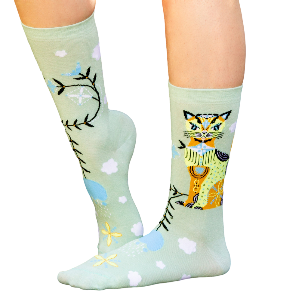 Studio shot of Cat & Clouds socks against a black backdrop. [lf]