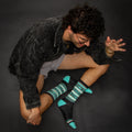 Overhead shot of a person sitting, showcasing the socks. A casual style is depicted. [lf]