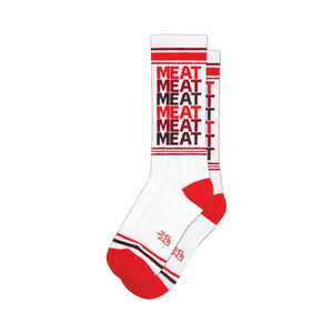 White crew socks with a repeating 'MEAT' pattern in red and brown. Red and brown stripes at the cuff and heel.